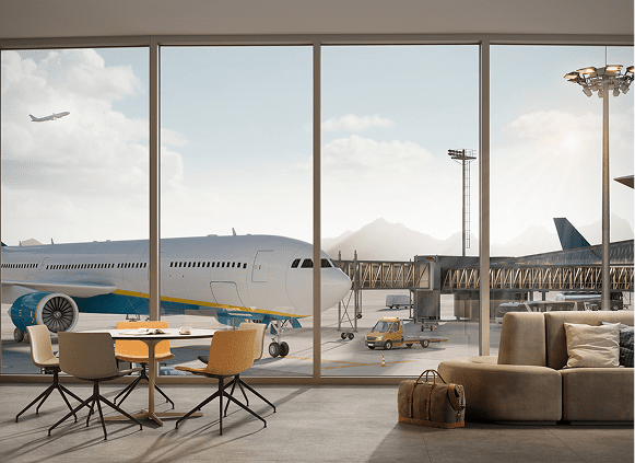 Airport lounge view with airplane and mountains.