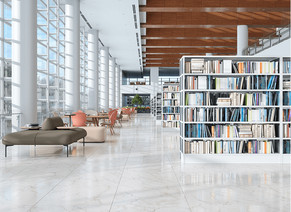 Modern library interior with bookshelves and seating.