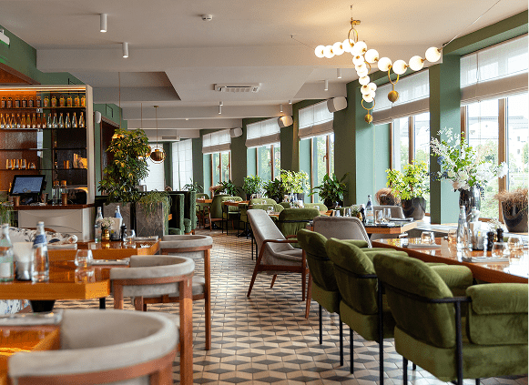 Modern restaurant interior with green accents.