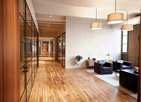 Modern office hallway with seating area.