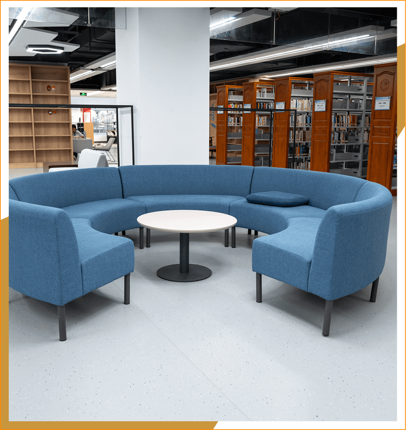 Blue curved sofa in modern library.